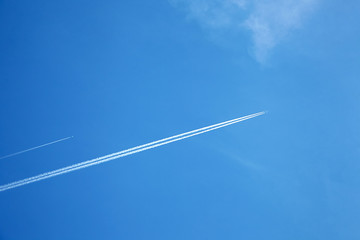 Planes in the blue sky. The aircraft leaves traces