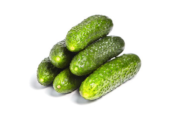 Heap of whole green gherkins isolated on white background