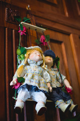 Dolls in national clothes on hanging swings