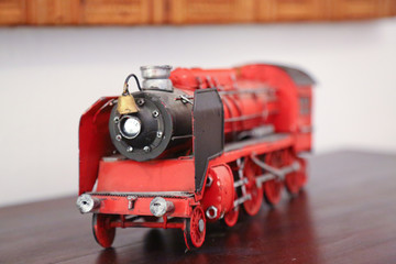 red steam locomotive model isolated on table