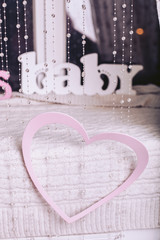 Hanging pink hearts and a baby sign. Decorative elements for Valentine's Day