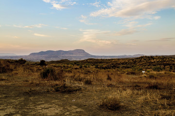 sunrise over the mountains in a grassland desert landscape