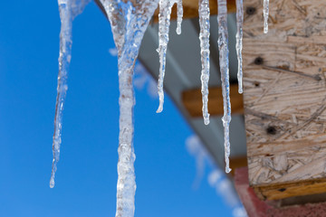 Icicles on vintage roof closeup. Winter weather concept. Froze and ice background. Christmas weather concept. Snow and icicle. Melting icicles. Long sharp icicles. Frozen water. Cold weather concept