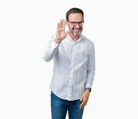 Fototapeta premium Handsome middle age elegant senior business man wearing glasses over isolated background Waiving saying hello happy and smiling, friendly welcome gesture