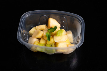 banana salad with apples in box, healthy meal
