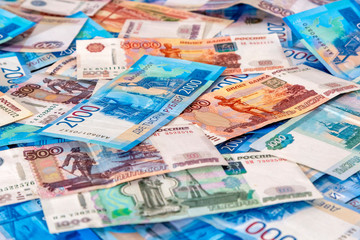 Obraz na płótnie Canvas Russian cash money 5000, 2000, 1000, 500 lying on plane. Rubles banknote as background, closeup