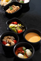 eco food containers with proper nutrition, asian salad and pea soup with pumpkin, steamed food