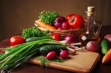 Appetizing vegetables and olive oil on the table.