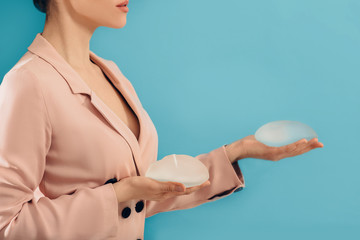 woman holding breast silicone implants. Augmentation breast size, breast Surgery.