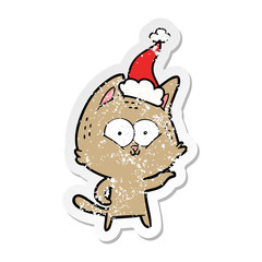 distressed sticker cartoon of a cat wearing santa hat