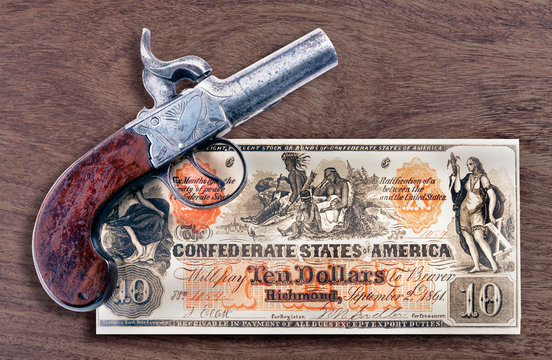 Antique Pistol and Confederate Money.
