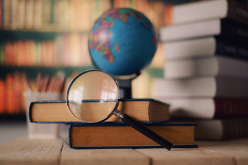 Textbooks,  globe and pencils on a wooden background. Educational background