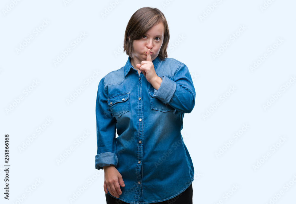 Sticker young adult woman with down syndrome over isolated background asking to be quiet with finger on lips