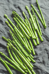 Fresh asparagus on a grey linen kitchen towel. Preparation vegetarian healthy food.