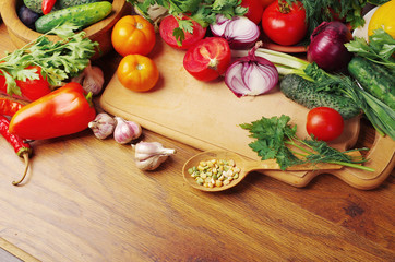 A variety of vegetables on the kitchen board.