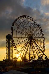 Ferris wheel on amazing sunset sky background