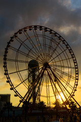 Ferris wheel on amazing sunset sky background