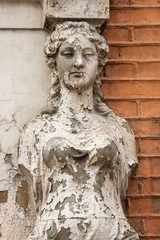 Old Caryatid in a brick house
