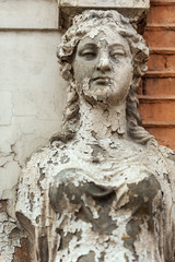 Old Caryatid in a brick house