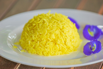 Turmeric Rice and Butterfly pea on white plate.
