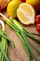 lemon , green onion, lemon leaf of salad on a wooden surface.Fresh vegetables