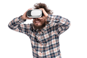 Crazy bearded Man in plaid shirt with funny Haircut wearing virtual reality helmet, isolated on white background. Portrait of funny man using VR goggles.
