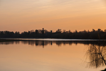Fototapeta premium Sunset over the river and trees