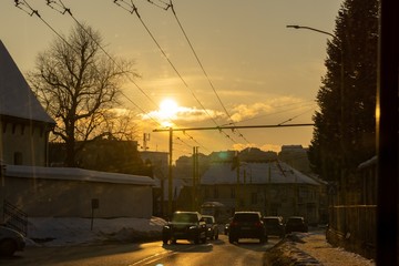 Fototapeta na wymiar Sunset on the street with snow during winter. Slovakia