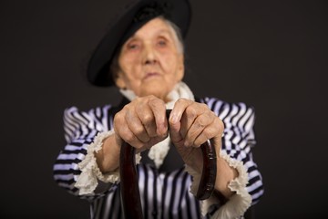 Old grandma in a white-black striped jacket