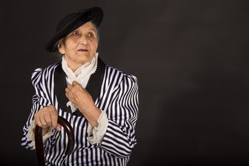 Old grandma in a white-black striped jacket