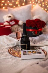 Fototapeta na wymiar surprise for the beloved, a gift for March 8: Handmade chocolate, a glass of champagne, roses