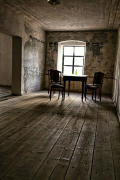 Old house room with wooden floor, chairs and table