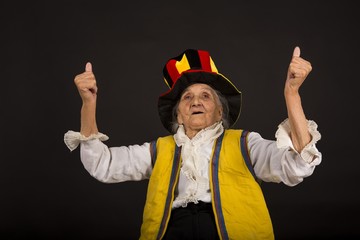 vintage old woman wearing cylinder and a yellow vest