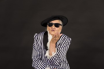 Old grandma in a white-black striped jacket