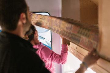 Young couple painting and restoring caravan - obrazy, fototapety, plakaty
