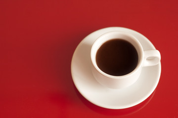 top view cup of black coffee on a red background copy space