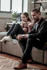 Obraz premium Father and daughter sitting on sofa after big nervous quarrel