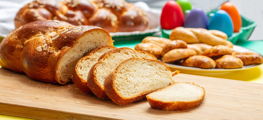 Easter tsoureki braid slices, greek easter sweet bread, on wood