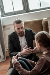 Bearded psychologist giving instructions to stressed teenager