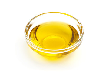 Olive oil in bowl, close-up, isolated on white background