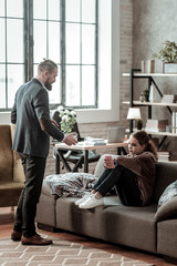 Psychologist bringing glass of water to stressed teenage girl