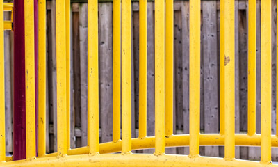 Playground Equipment in Front of a Fence
