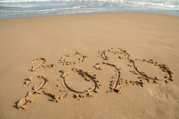 2020 Year written on the beach sand