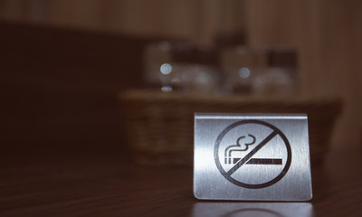 Warning sign. no smoking on the table in the room. Iron plate on the table does not smoke close-up. horizontal view.