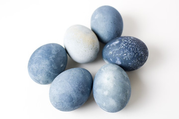 Six colored blue, gray, stone-like marble eggs