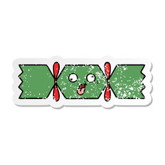 distressed sticker of a cute cartoon christmas cracker