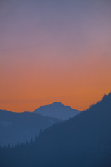 Fototapeta na wymiar Portrait view over valley Ennstal to sunset over mountain Gumpeneck