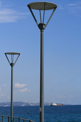 Two street lamps on a sea pier