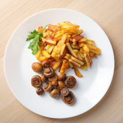 fried potatoes with mushrooms top view