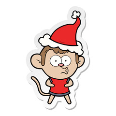 sticker cartoon of a surprised monkey wearing santa hat